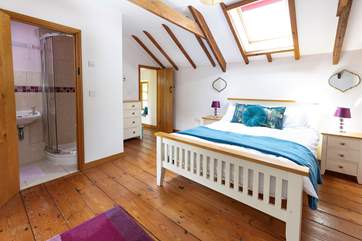 The delightful double bedroom is light and bright thanks to the Velux window.