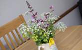 Pretty flowers on the table add welcome. - Thumbnail Image