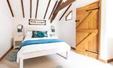 An inviting double bed sits in the centre of bedroom one. - Thumbnail Image