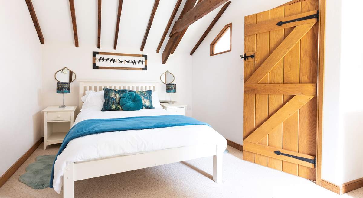 An inviting double bed sits in the centre of bedroom one.