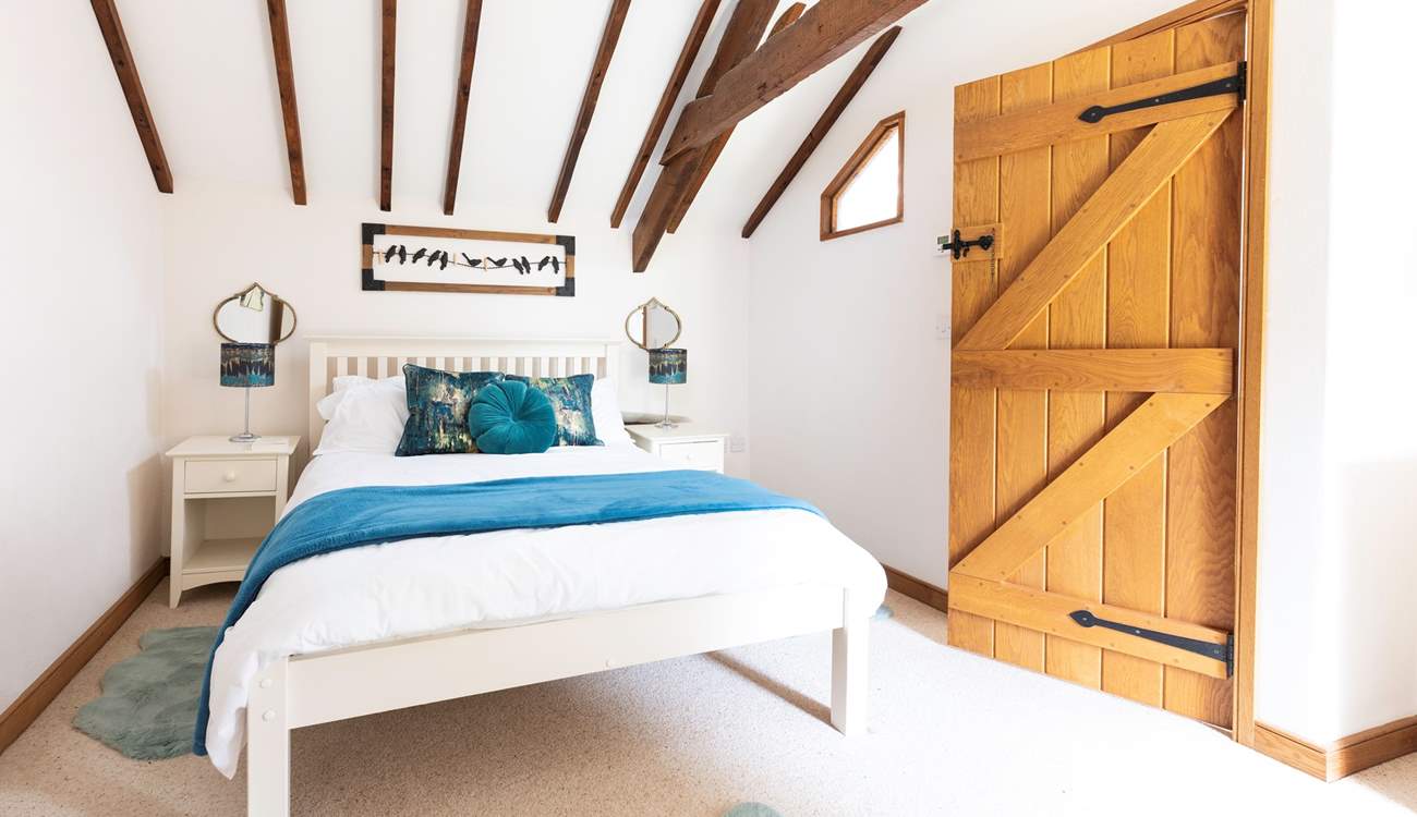 An inviting double bed sits in the centre of bedroom one.