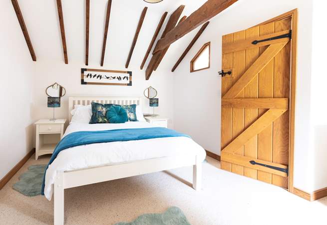 An inviting double bed sits in the centre of bedroom one.