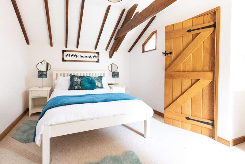 An inviting double bed sits in the centre of bedroom one.