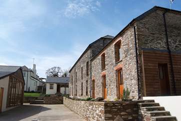 Aveton Cottage on the right, adjoining the owners' transport museum (not open to the public), the annexe next door and the rear of the main farmhouse at the top. The pool-room is shown on the left.