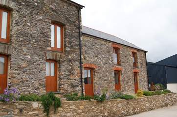 The owners' transport museum (not open to the public) on the left with the cottage to the right.