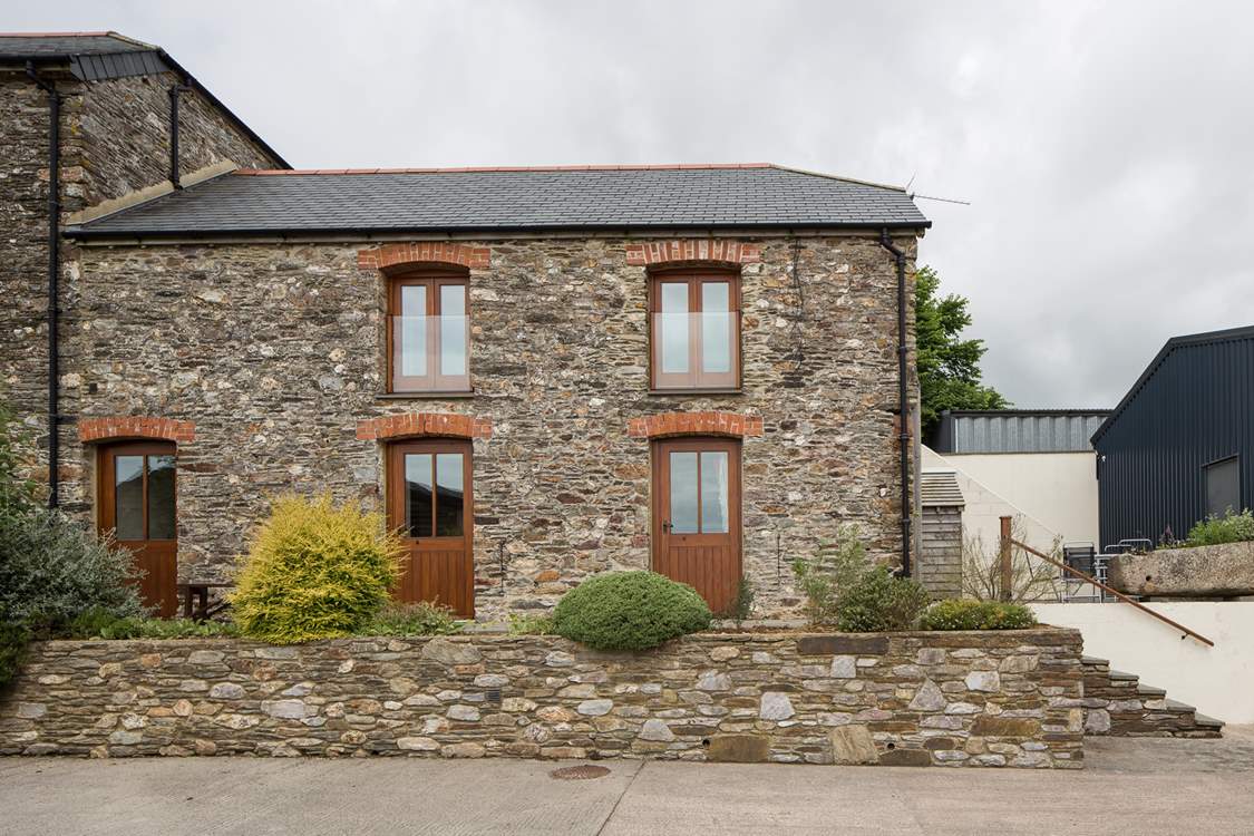 The front of the cottage with the patio at the top of the stairs.