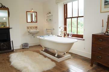 The bath in the master bedroom en suite is an old roll-top bath with Victorian hand shower attachment.