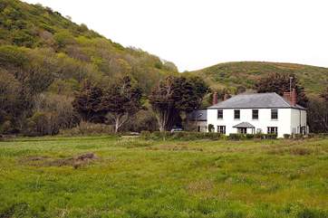 A view towards Meadowgate which stands alone in an enclosed garden.