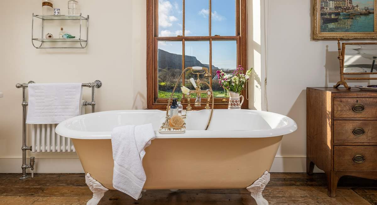 The bath in the master bedroom en suite is an old roll-top bath with Victorian hand shower attachment.