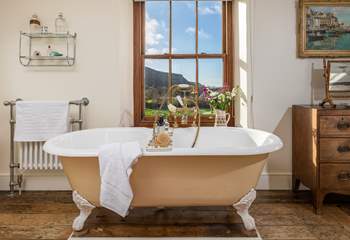 The bath in the master bedroom en suite is an old roll-top bath with Victorian hand shower attachment.
