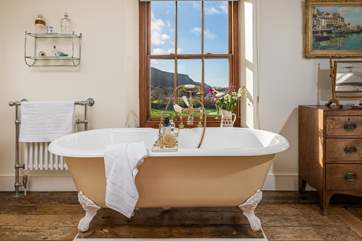 The bath in the master bedroom en suite is an old roll-top bath with Victorian hand shower attachment.
