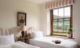 The pink twin bedroom is oh so pretty.  - Thumbnail Image