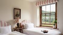 The pink twin bedroom is oh so pretty. 
