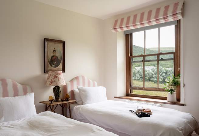 The pink twin bedroom is oh so pretty. 