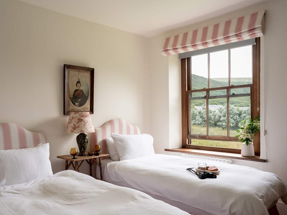 The pink twin bedroom is oh so pretty.