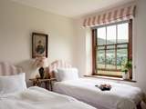 The pink twin bedroom is oh so pretty.