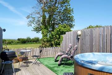 Poppy's private hot tub enclosure, with lovely views across the meadow and beyond. (Please note there is an additional charge for the hot tub).