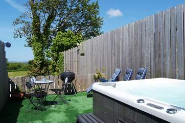 Daisy's private hot tub enclosure, with lovely views across the meadow and beyond.