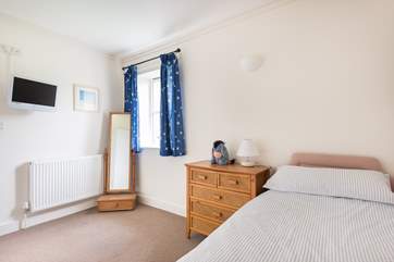 The single bedroom overlooks the field behind.
