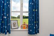 The single bedroom overlooks the field behind.
