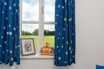 The single bedroom overlooks the field behind.