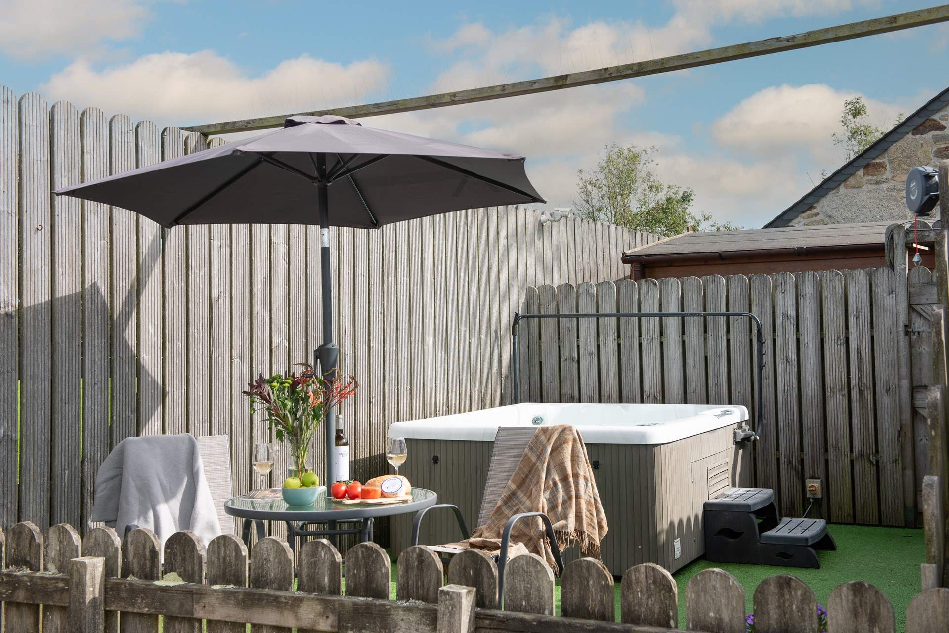 The private hot tub area is sheltered and boasts privacy.