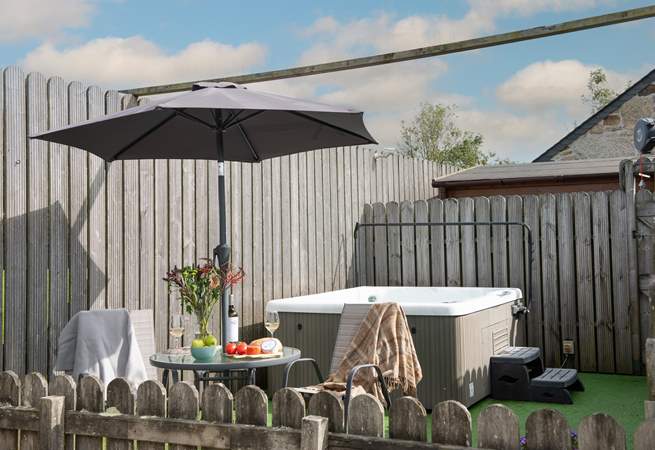 The private hot tub area is sheltered and boasts privacy.