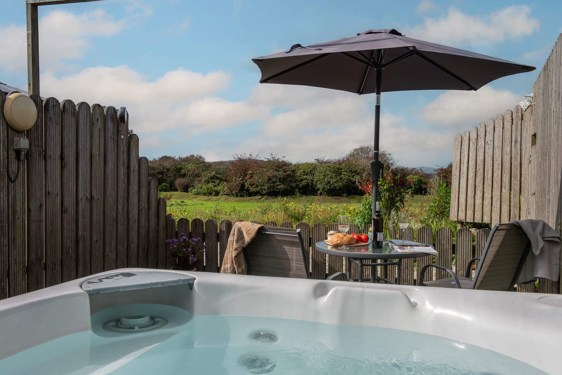 The hot tub looks across the meadow.