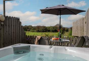 The hot tub looks across the meadow.