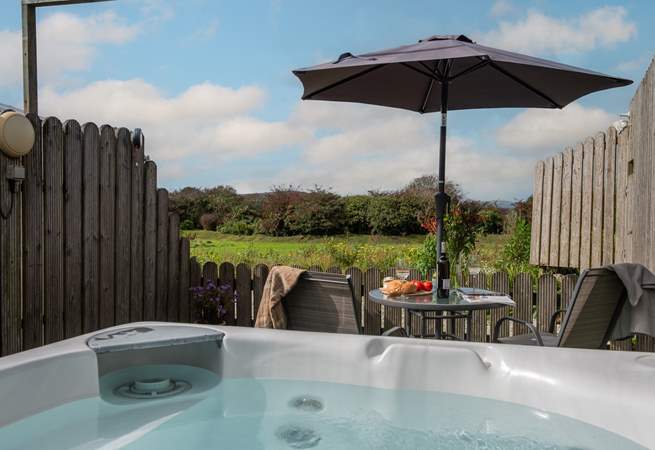 The hot tub looks across the meadow.