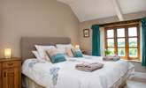 Bedroom 1 is beautifully furnished and enjoys views over the garden. - Thumbnail Image