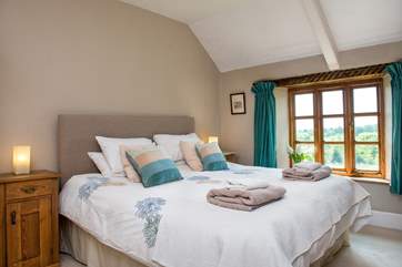 Bedroom 1 is beautifully furnished and enjoys views over the garden.