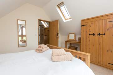 Another view of the double bedroom. There is plenty of storage and additional light from the Velux window.
