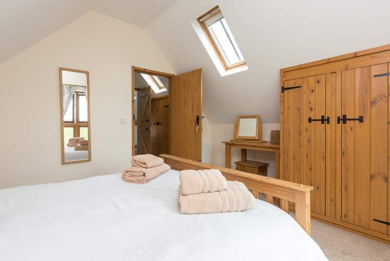 Another view of the double bedroom. There is plenty of storage and additional light from the Velux window.