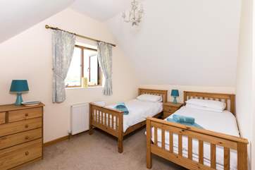 This is the twin bedroom. This room is very spacious and looks far across the farmland with a glimpse of the Quantock Hills in the distance.