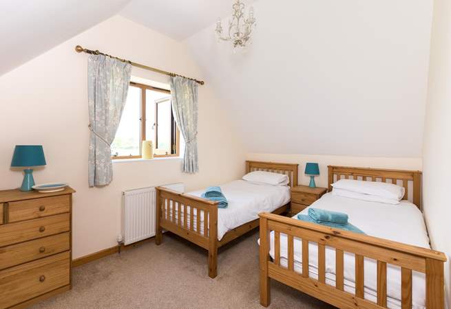 This is the twin bedroom. This room is very spacious and looks far across the farmland with a glimpse of the Quantock Hills in the distance.