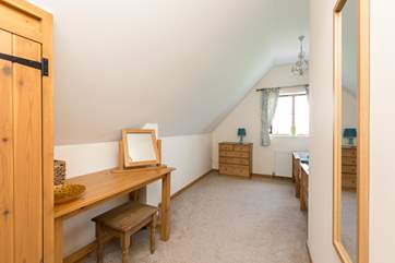 The twin bedroom is in a generous L-shape with the beds tucked around the corner.