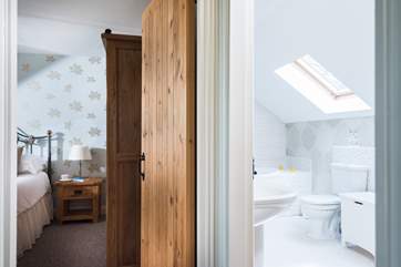 The bathroom is adjacent to the bedroom.