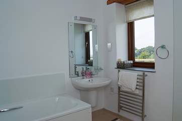 The bathroom (next to Bedroom 1) includes a wet-room shower as well as a bath.