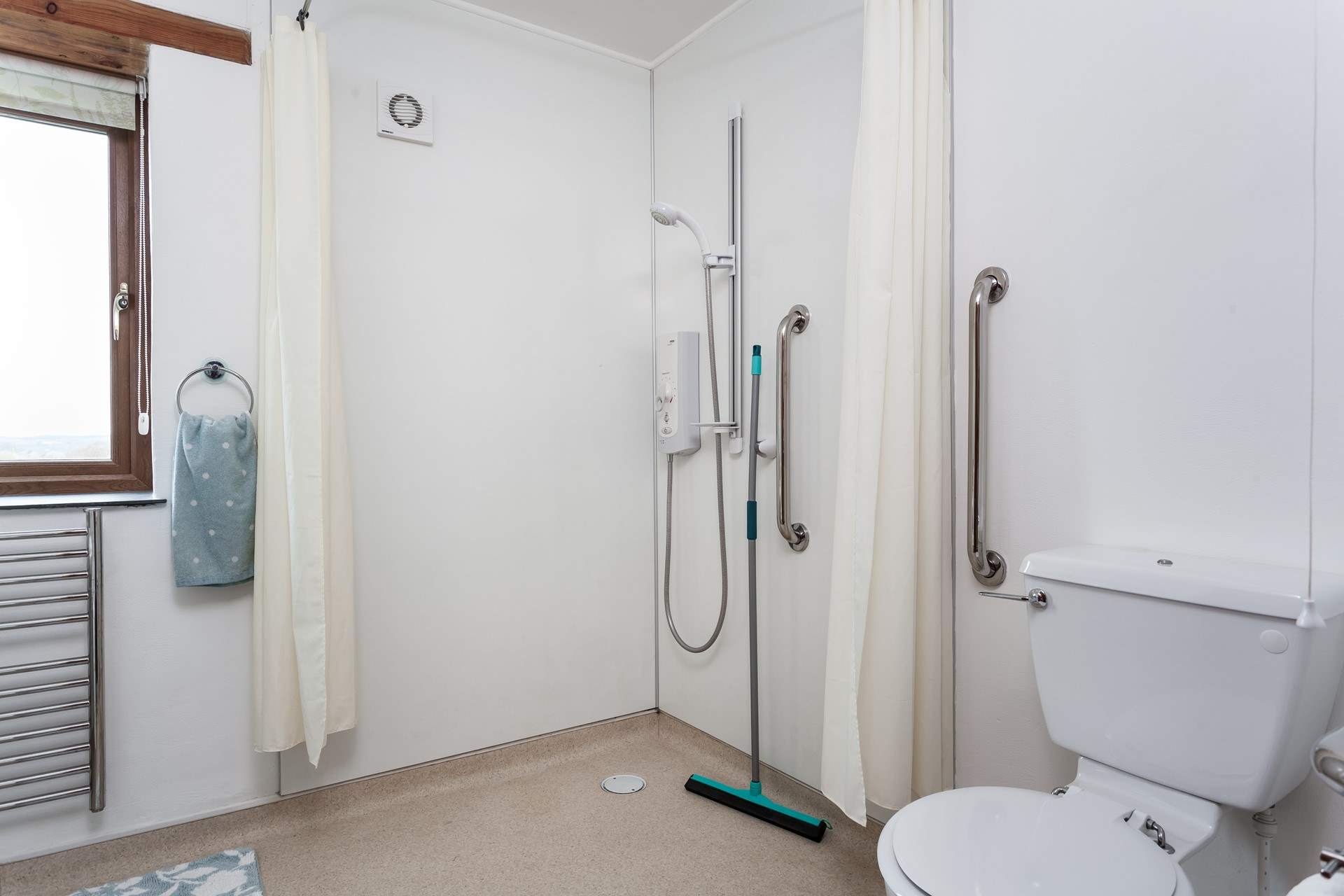 The wetroom is has a shower and a bath for Bedroom 1. 