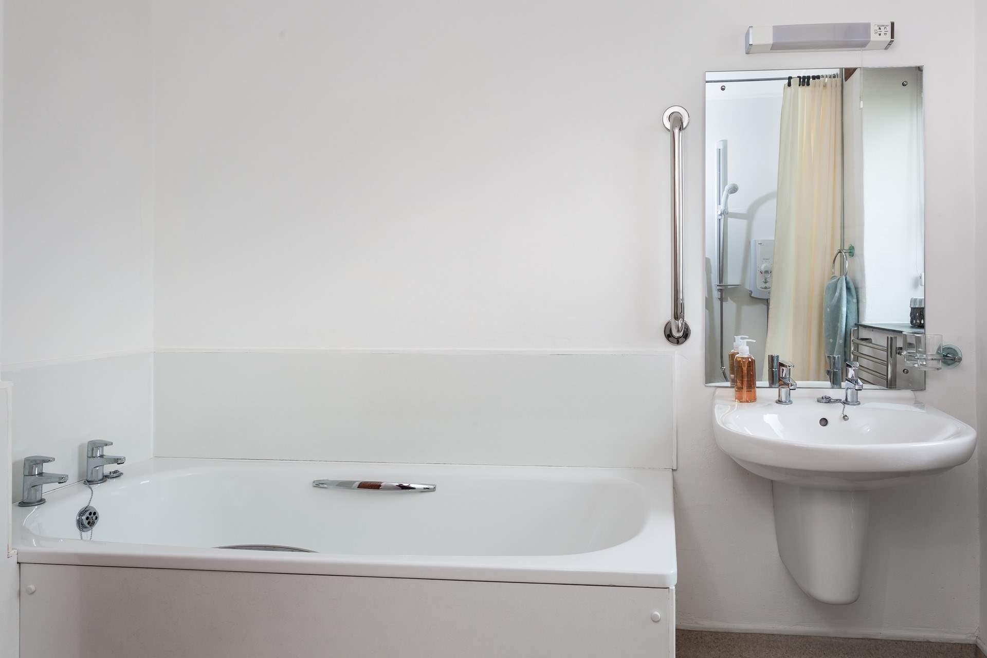 The bathroom (next to Bedroom 1) includes a wet-room shower as well as a bath.