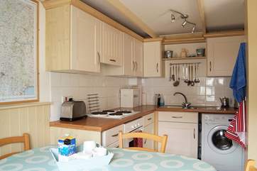 The well-equipped kitchen and dining-area.