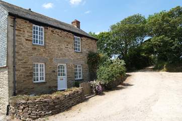 The little front terrace leads round to the private enclosed side garden. The private parking-area is a few yards beyond the cottage, on the left.