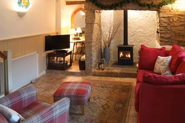 The living-room with comfy chairs and a cosy wood-burner to keep you toasty on those cooler days and evenings.