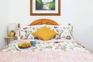 The lovely and light bedroom with a double bed.