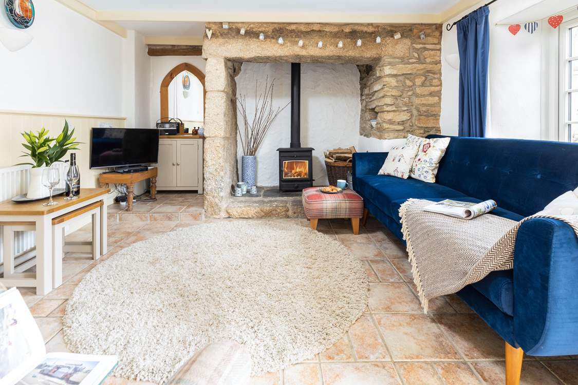 The cosy living-room with a crackling fire for those cooler evenings.