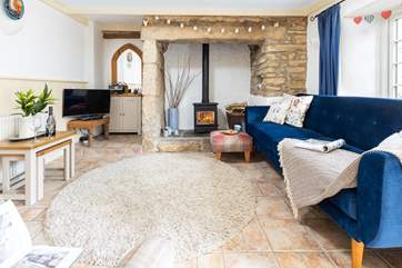 The cosy living-room with a crackling fire for those cooler evenings.
