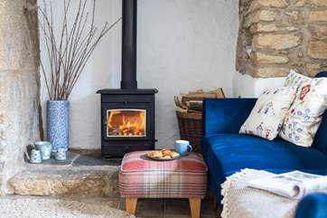 The living-room with comfy chairs and a cosy wood-burner to keep you toasty on those cooler days and evenings.