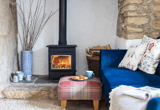 The living-room with comfy chairs and a cosy wood-burner to keep you toasty on those cooler days and evenings.