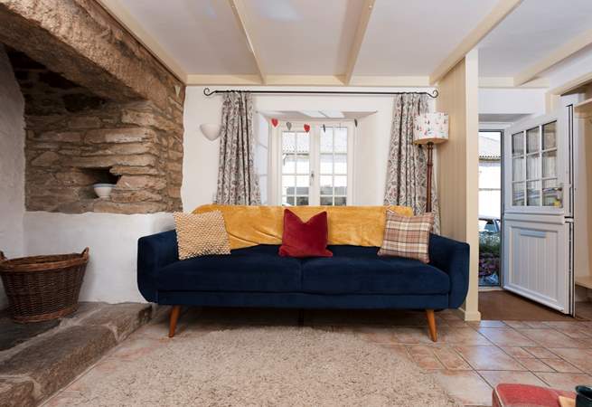 The sitting room boasts a stable door and inglenook fireplace.